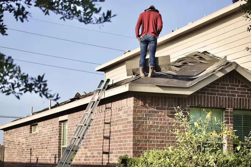 Professional roofer working on a residential roof in Country View